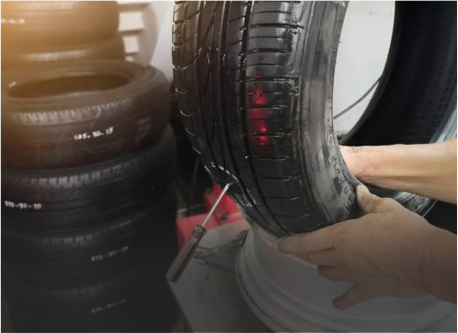 mechanic is repairing car tyre puncture